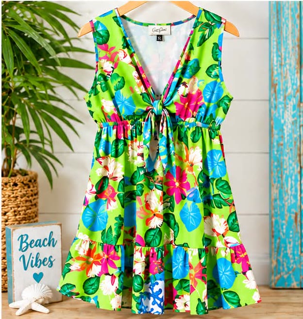 Sleeveless lime green dress with pink and blue tropical flowers, a tie front and a ruffle hem
