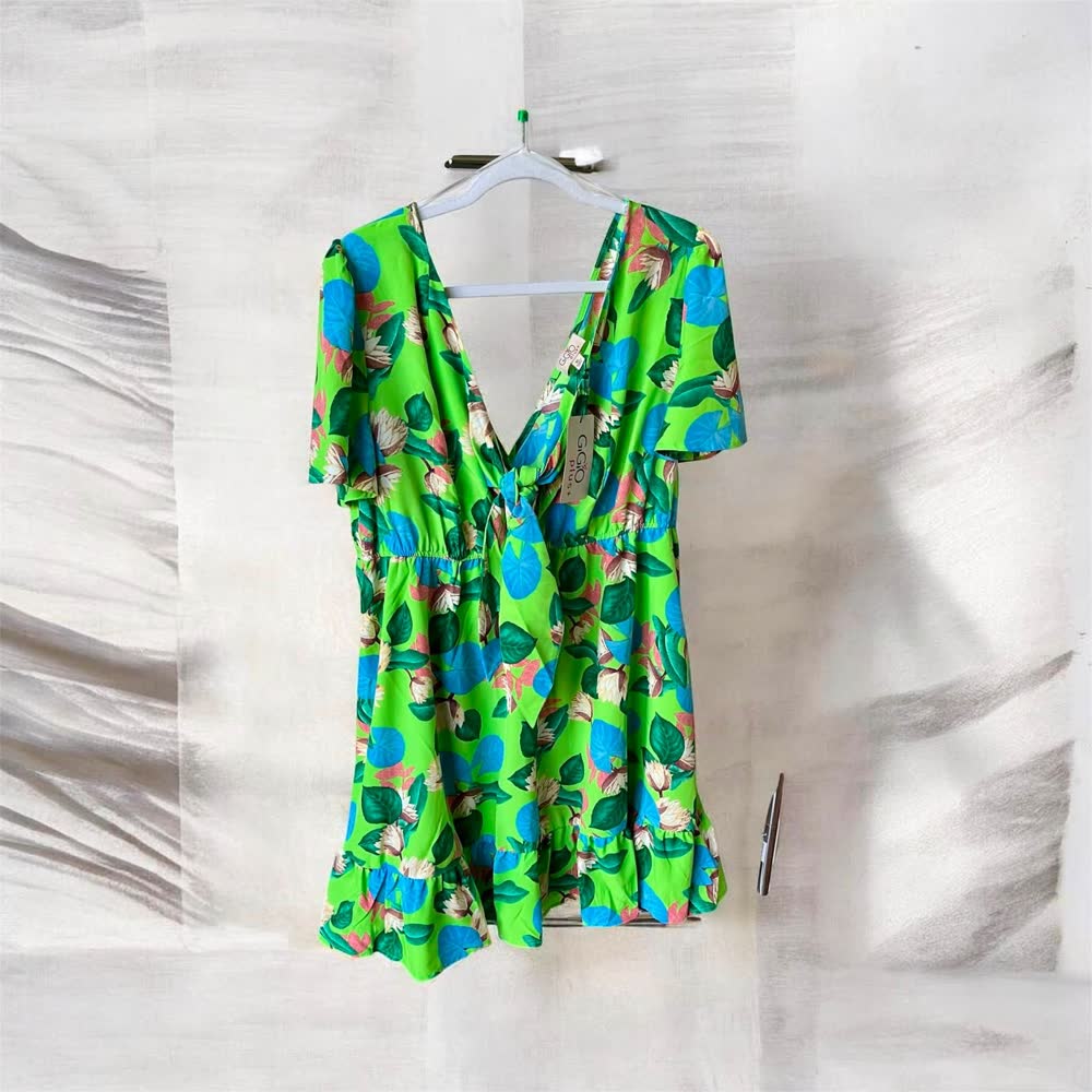 Bright green tropical print dress with flutter sleeves and a ruffle hem