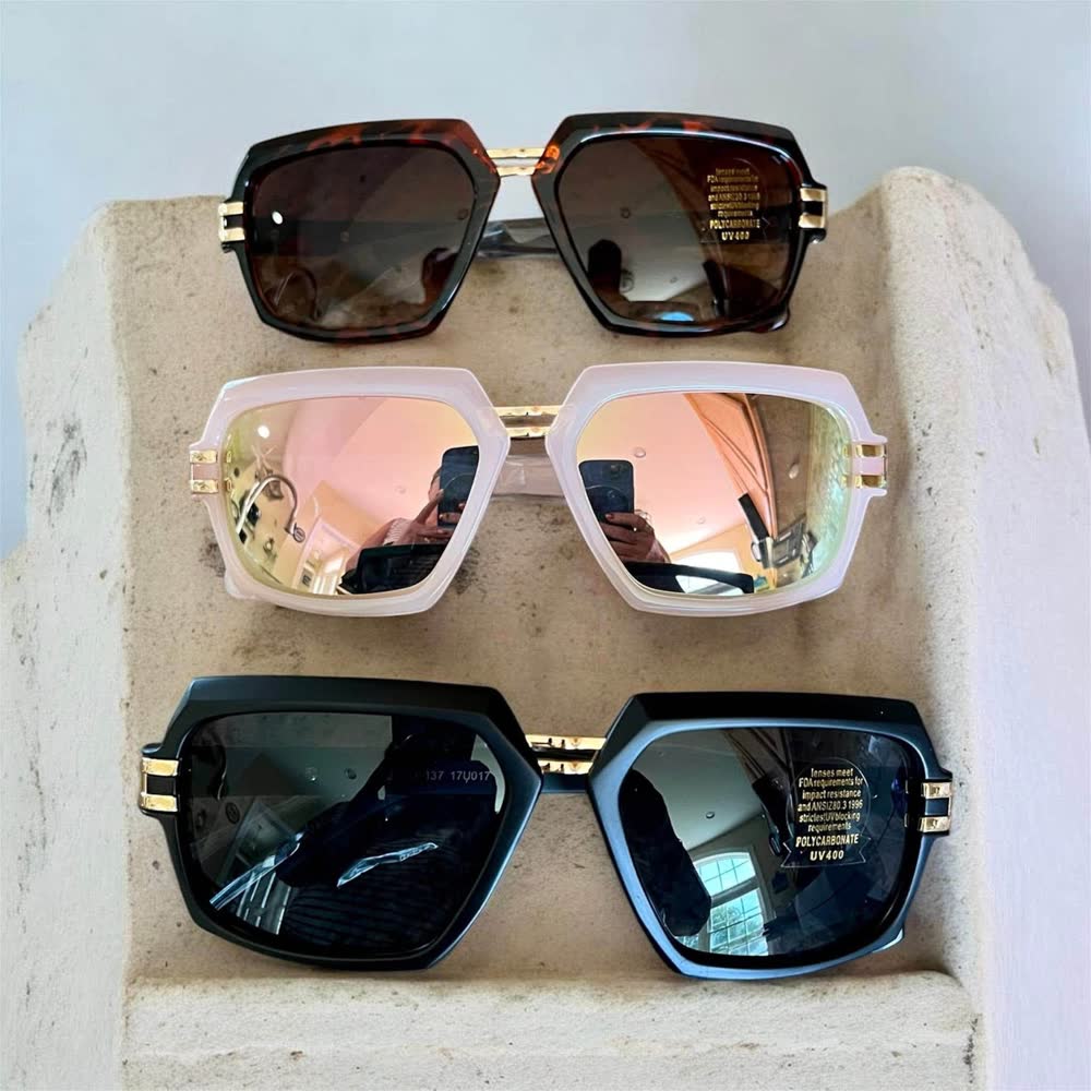 Three pairs of oversized square sunglasses in tortoise, pink mirror and black