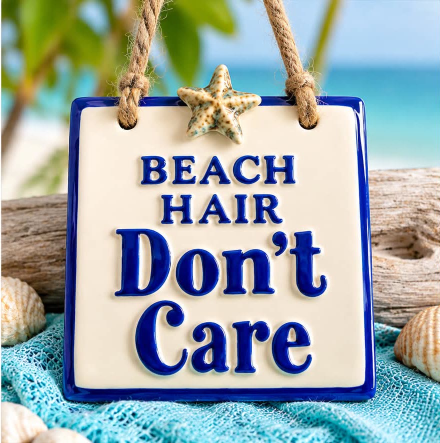 Small ceramic sign reading Beach Hair Don't Care, hung from a rope with a starfish