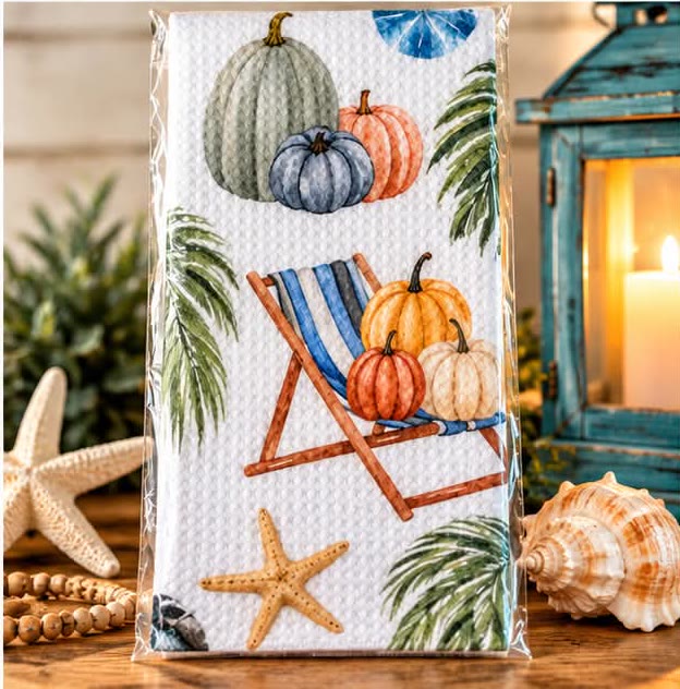 Waffle kitchen towel printed with a striped beach chair, pumpkins and starfish