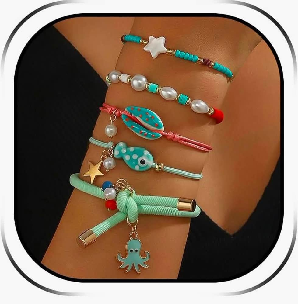 Stack of turquoise beaded bracelets with pearl, starfish, fish and octopus charms on a wrist