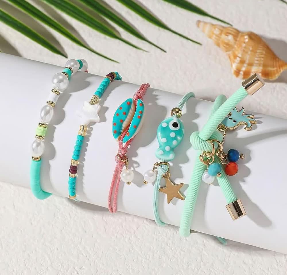 Five turquoise, pink and pearl bracelets with shell, fish and seahorse charms