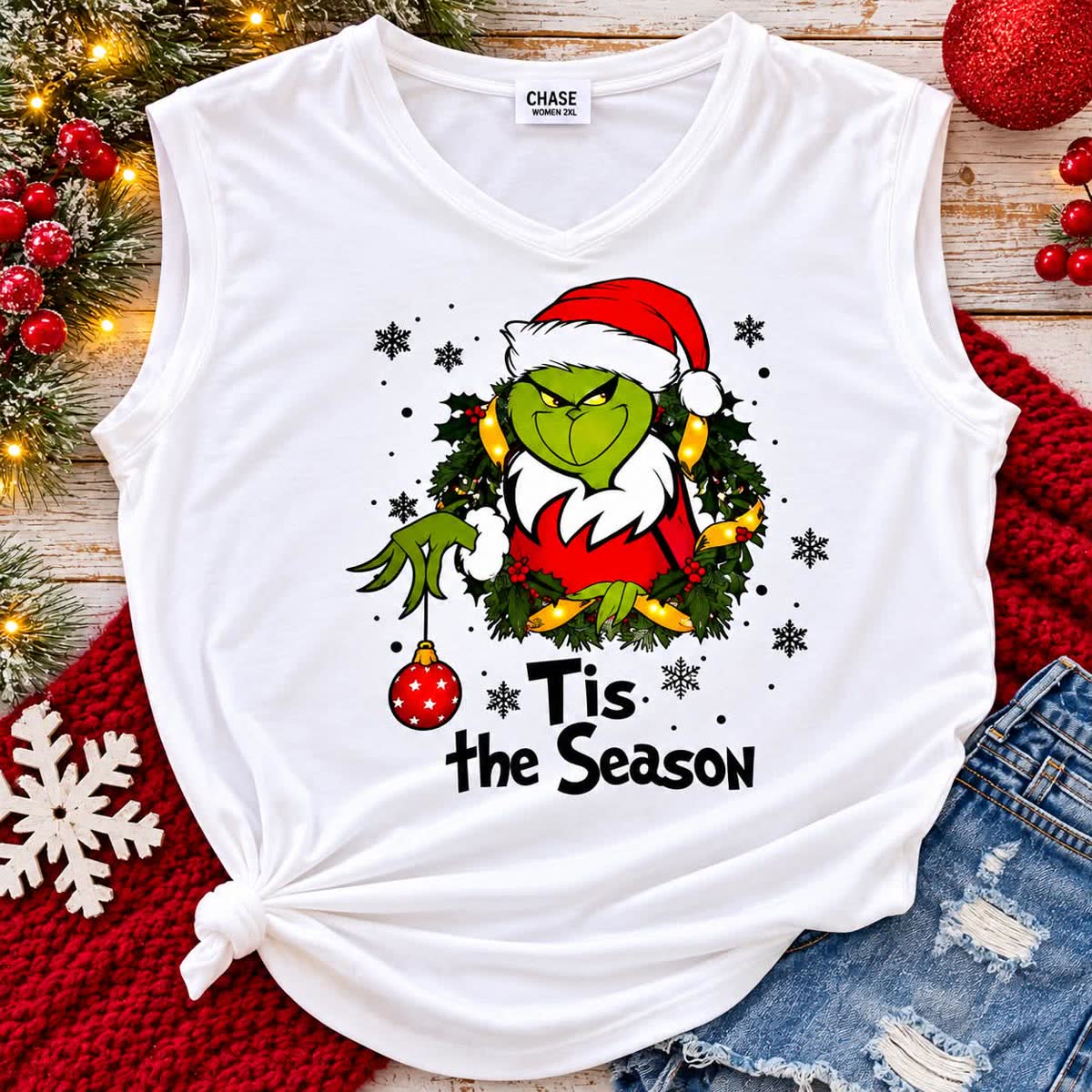 White sleeveless v-neck tee with a festive holiday wreath design and the words Tis the Season