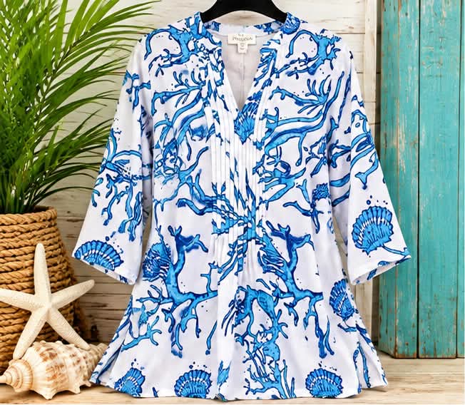 White v-neck tunic with a blue coral and seashell print and bell sleeves