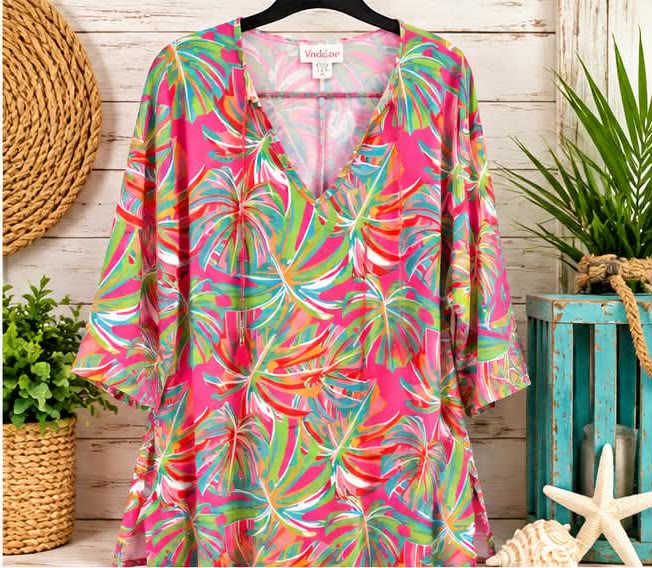 Pink v-neck tunic covered in green, coral and yellow palm leaf bursts